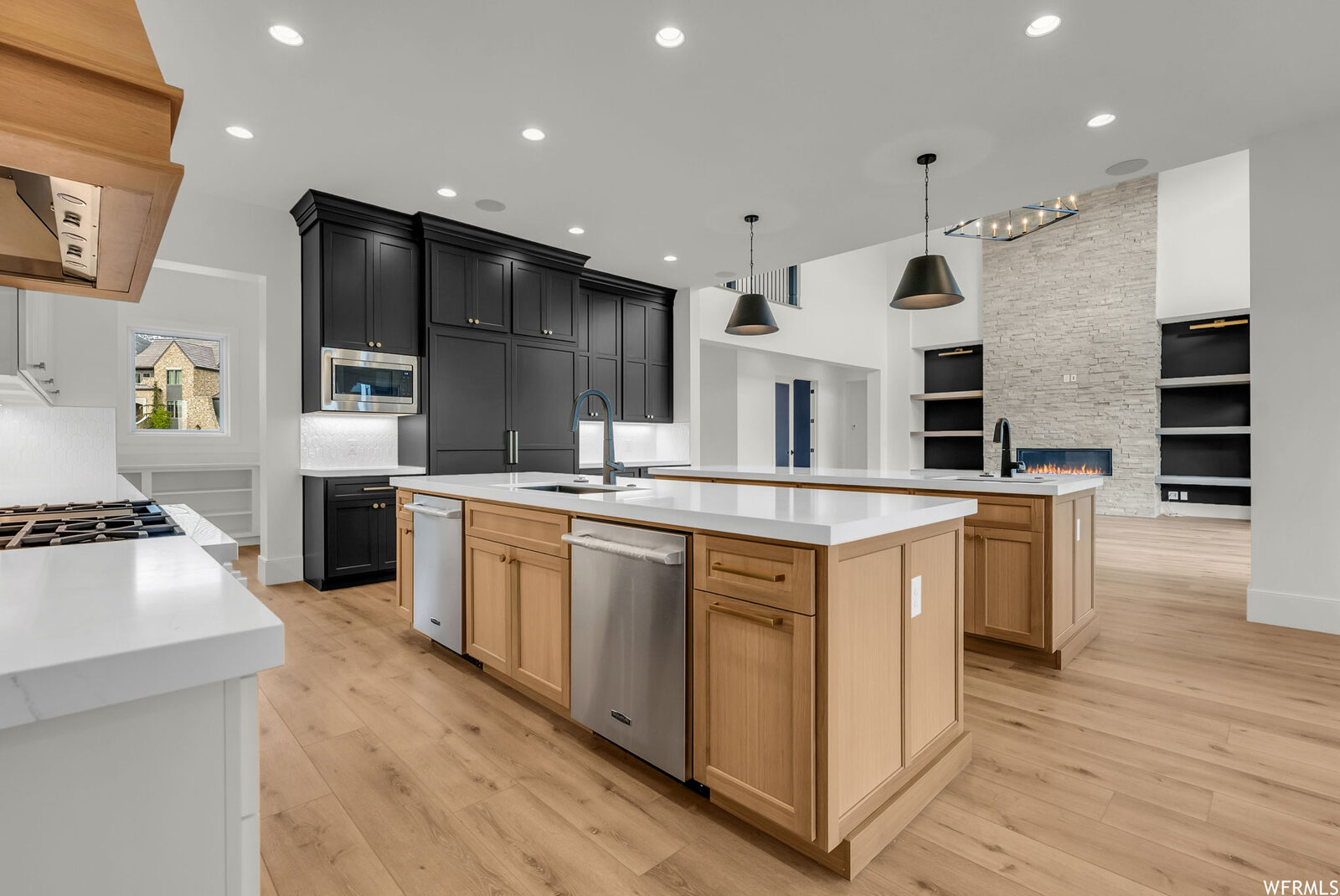 Kitchen with white oak island and black cabinetry