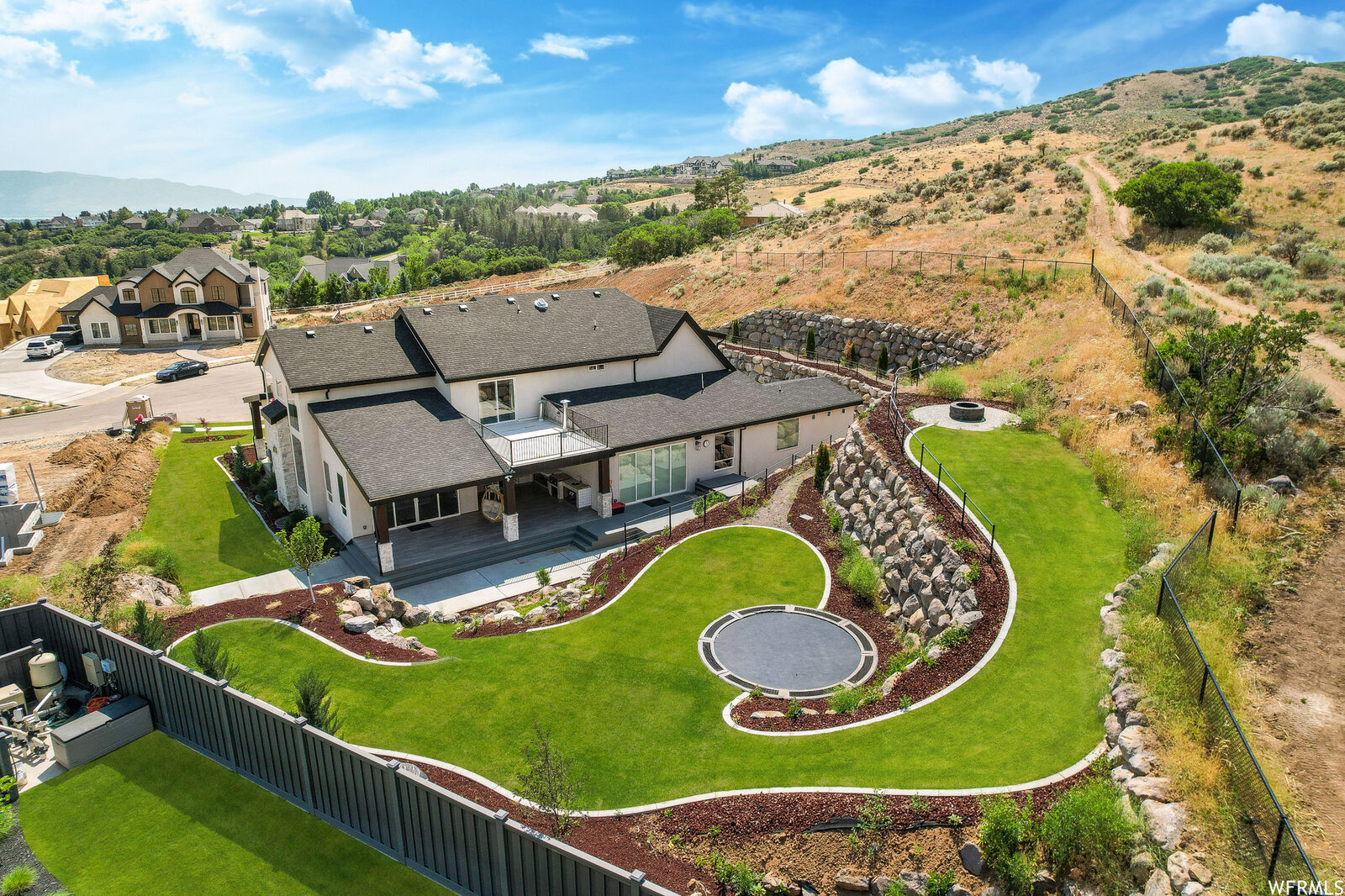 Aerial of the landscaped backyard with walking path and fire pit