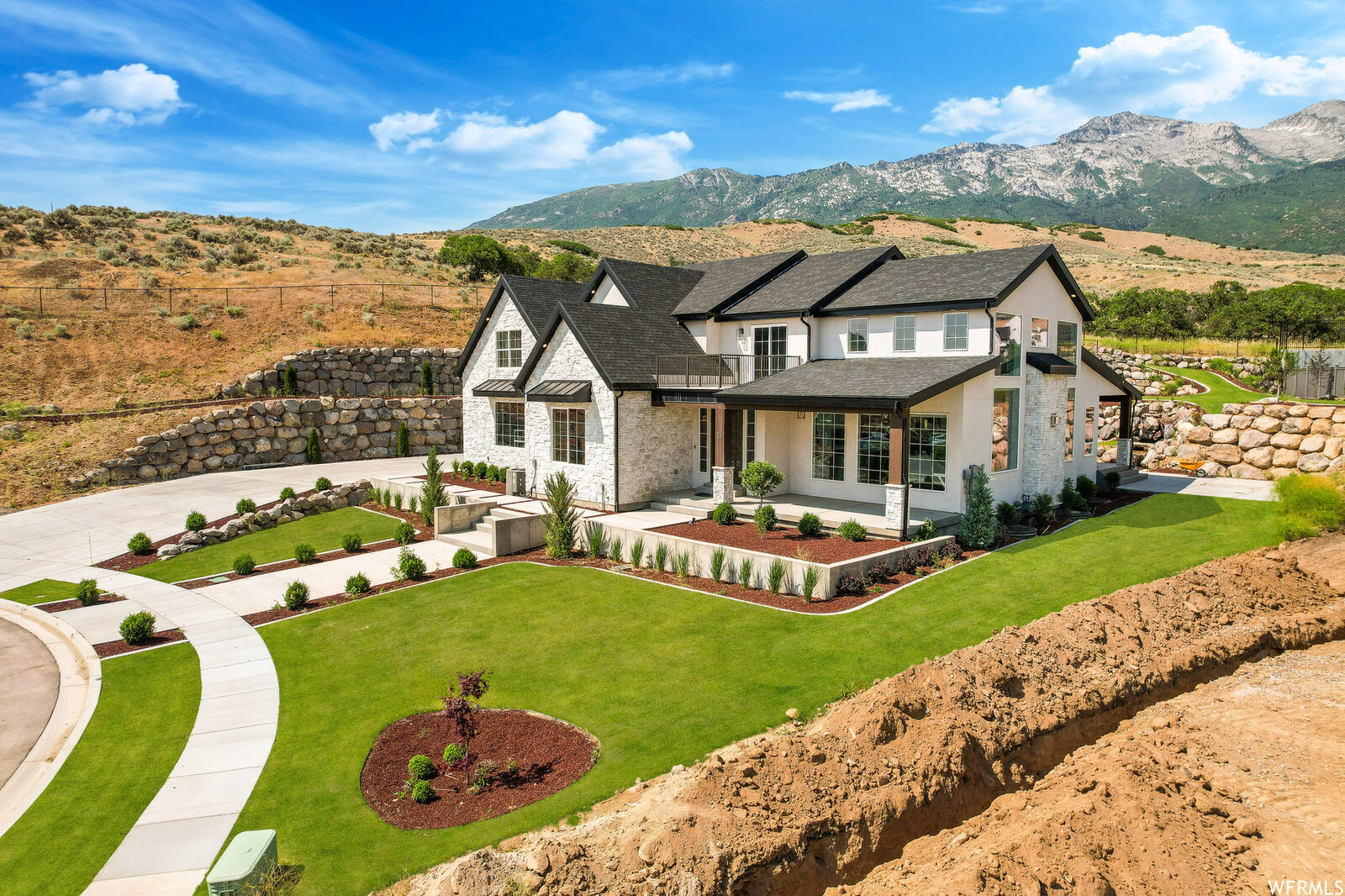 Aerial of the front of the home with the Wasatch behind