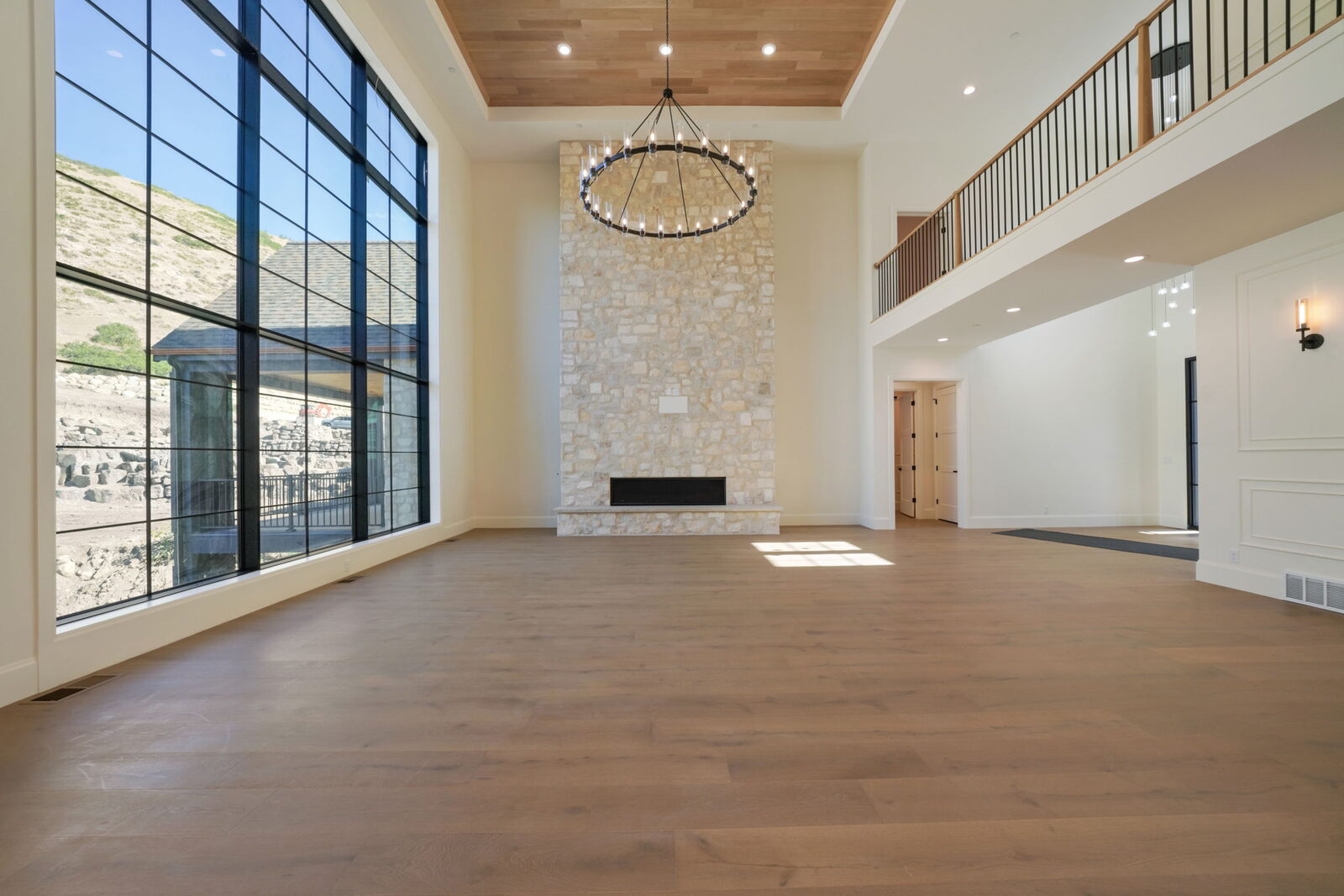 Two-story great room with stone fireplace and window wall