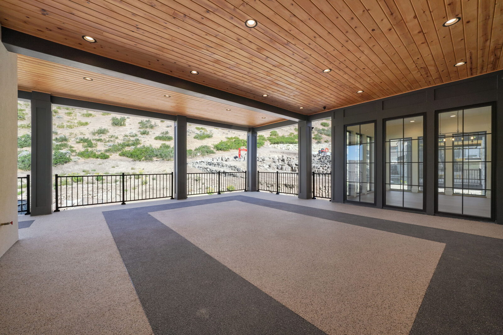 Covered deck with wood ceiling opening to the hillside