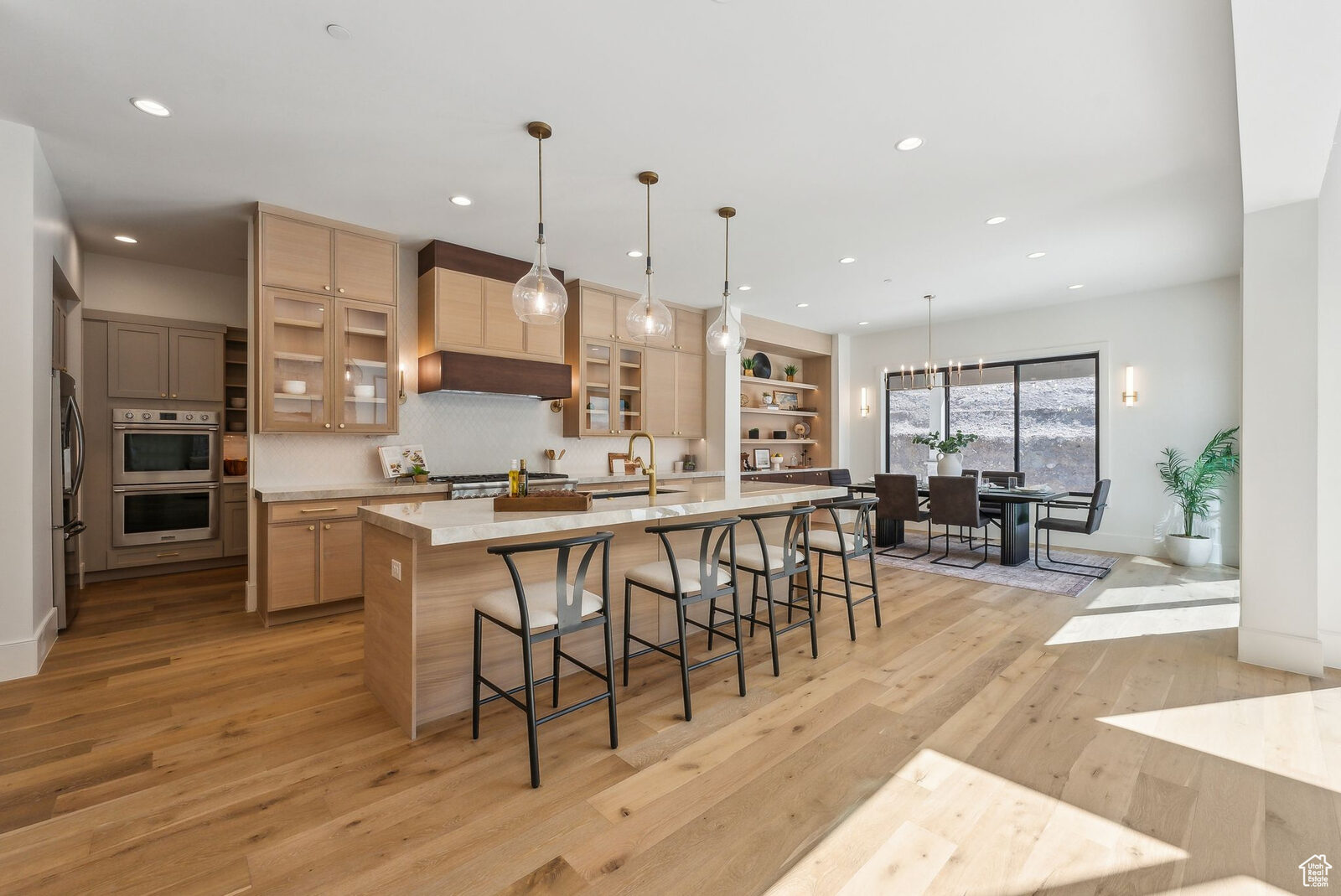 Kitchen with white oak cabinetry and island seating