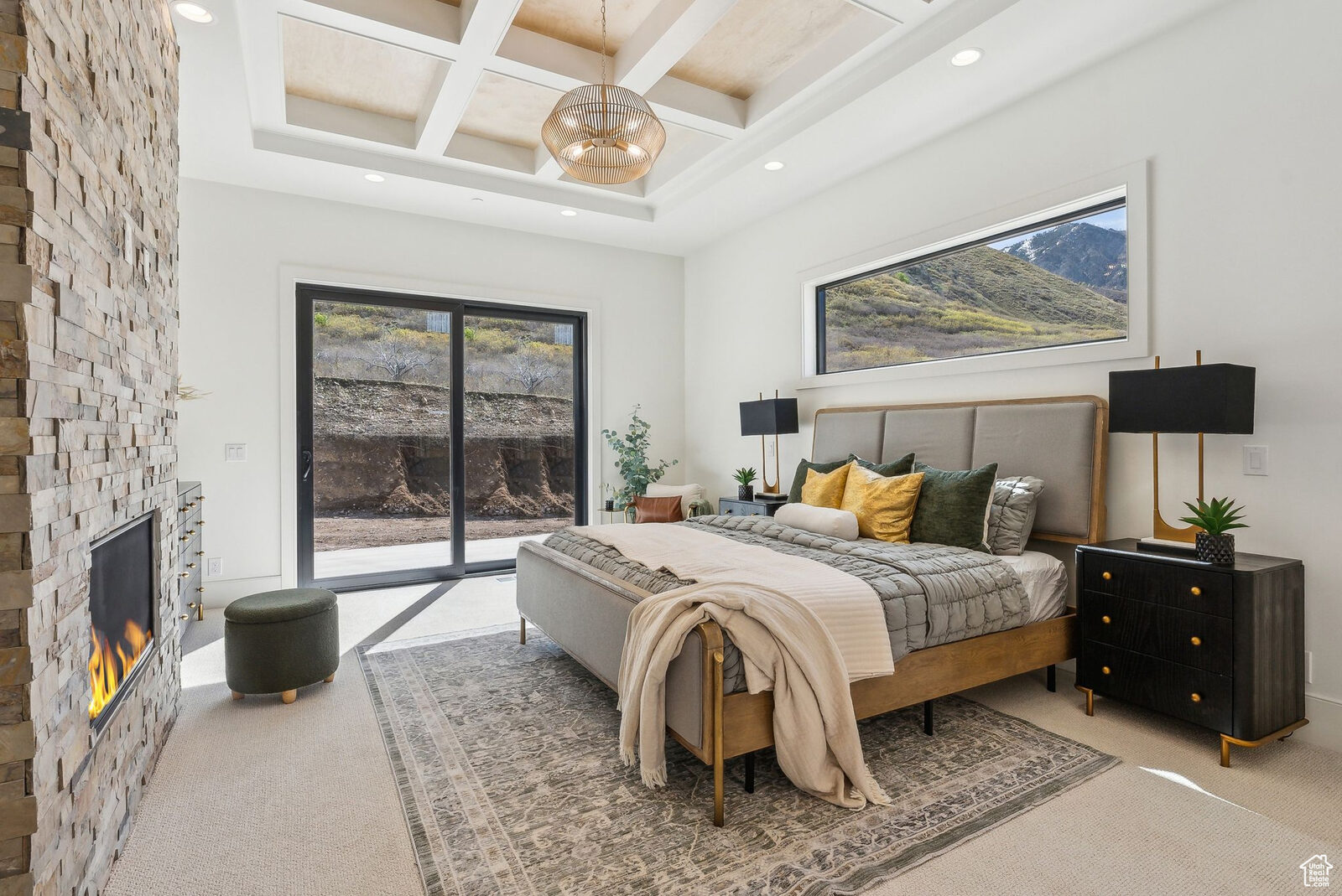 Primary bedroom with fireplace and mountain view