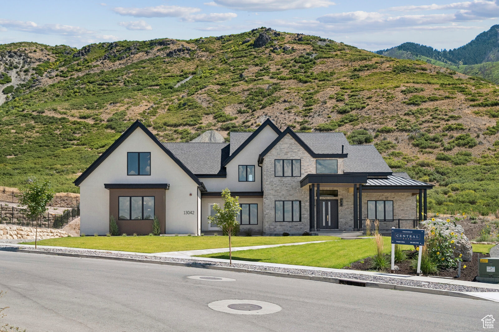 Front elevation of 13042 N Prospector Way against the Alpine bench